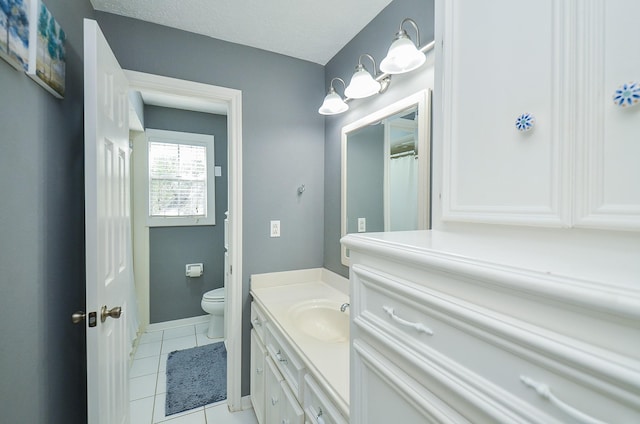 full bath with vanity, tile patterned flooring, baseboards, and toilet