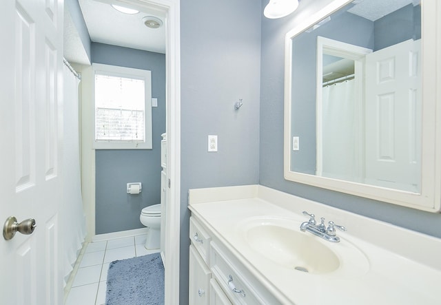 3114 E Ashfield Dr, Houston, TX 77082 - bathroom featuring tile patterned flooring, toilet, vanity, and baseboards