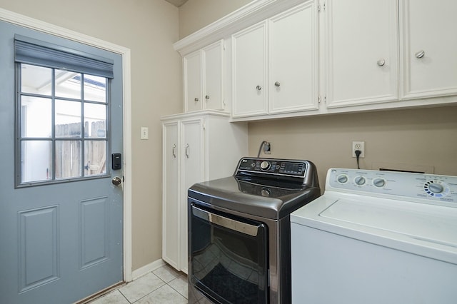 3114 E Ashfield Dr, Houston, TX 77082 - washroom featuring cabinet space, separate washer and dryer, light tile patterned floors, and baseboards