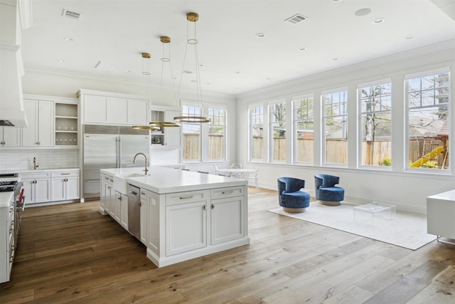 2023 Drexel Dr, Houston, TX 77027 - kitchen featuring open shelves, crown molding, visible vents, stainless steel appliances, and light countertops