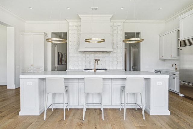 2023 Drexel Dr, Houston, TX 77027 - kitchen with stainless steel built in fridge, light countertops, backsplash, a sink, and visible vents