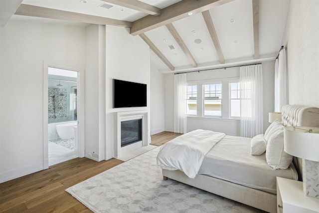 2023 Drexel Dr, Houston, TX 77027 - bedroom featuring visible vents, vaulted ceiling with beams, wood finished floors, and a glass covered fireplace