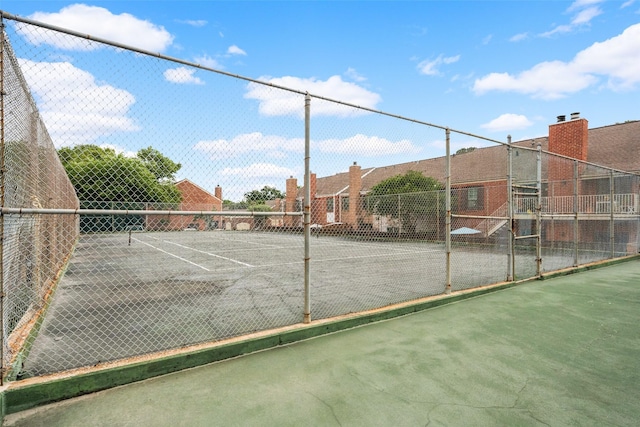 view of tennis court with fence