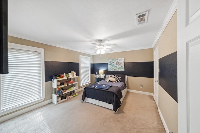 bedroom featuring visible vents, crown molding, carpet floors, baseboards, and ceiling fan