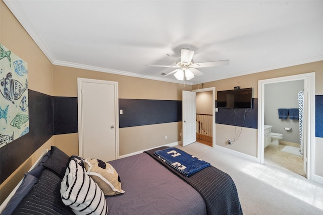 carpeted bedroom with baseboards, ornamental molding, connected bathroom, and ceiling fan