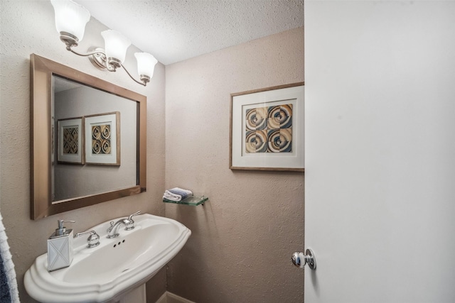 bathroom with a textured ceiling and a sink