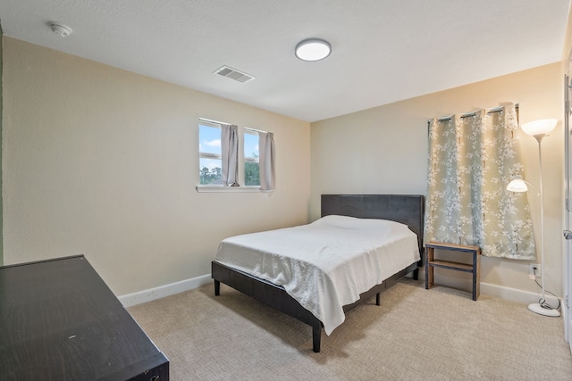 carpeted bedroom with baseboards and visible vents