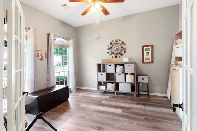 office space with baseboards, visible vents, ceiling fan, and light wood finished floors