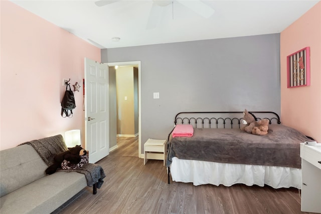 bedroom featuring a ceiling fan, wood finished floors, and baseboards