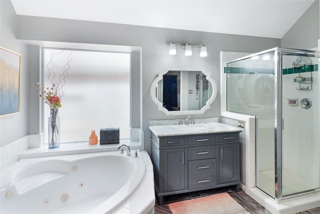 full bath with vanity, a jetted tub, and a stall shower