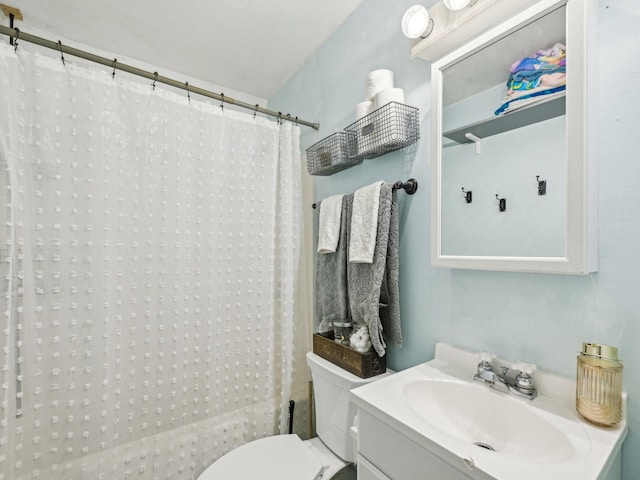 bathroom with a shower with curtain, toilet, and vanity