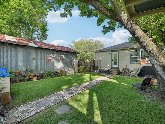 view of yard with fence and entry steps