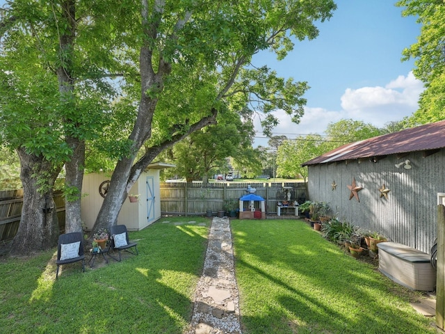 view of yard featuring an outdoor structure, a storage unit, and a fenced backyard