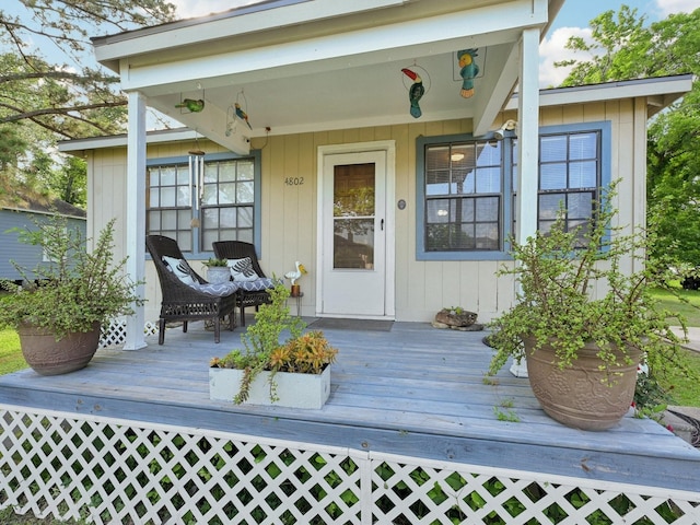 entrance to property featuring a wooden deck and fence