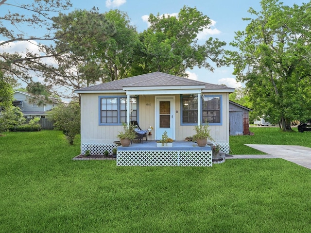 bungalow-style house with covered porch and a front lawn