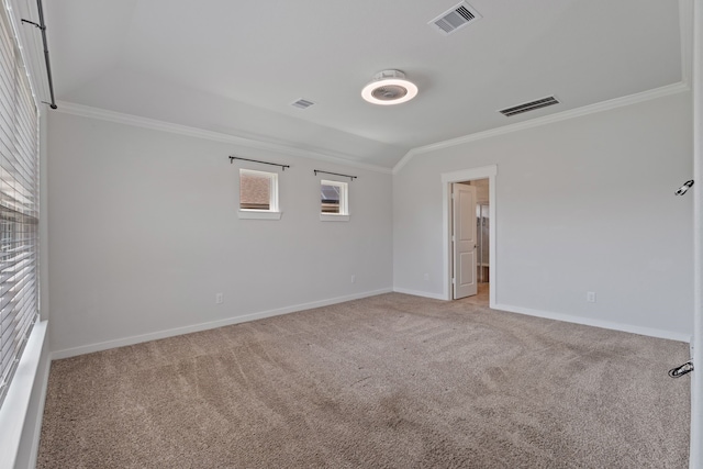 empty room with crown molding, baseboards, visible vents, and carpet