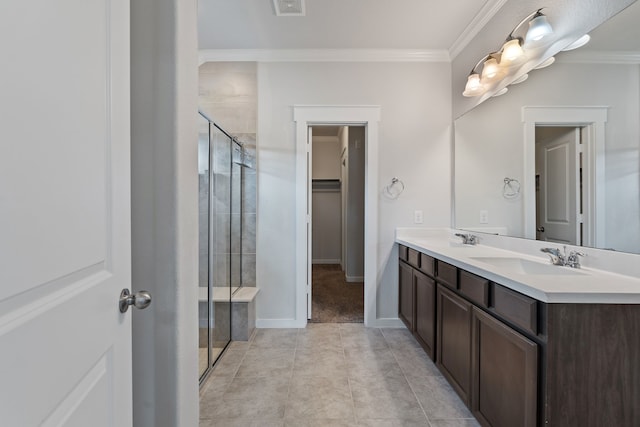 bathroom featuring a sink, a stall shower, and ornamental molding