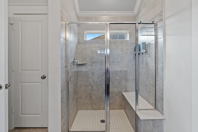 full bath with ornamental molding and a stall shower