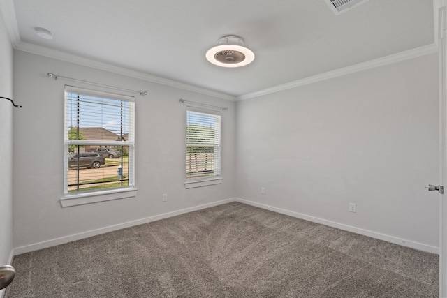 empty room with carpet floors, crown molding, visible vents, and baseboards