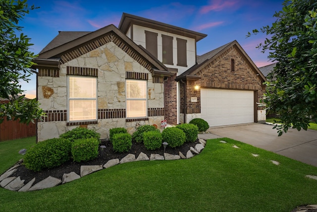 view of front of property featuring concrete driveway, a front lawn, stone siding, and a garage
