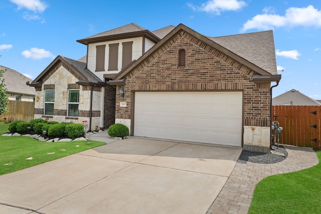 view of front of house featuring brick siding, a shingled roof, fence, and concrete driveway
