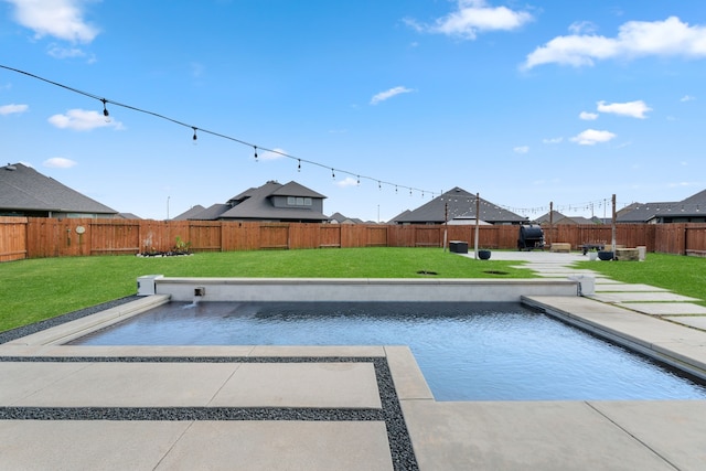 view of swimming pool with a fenced backyard and a yard