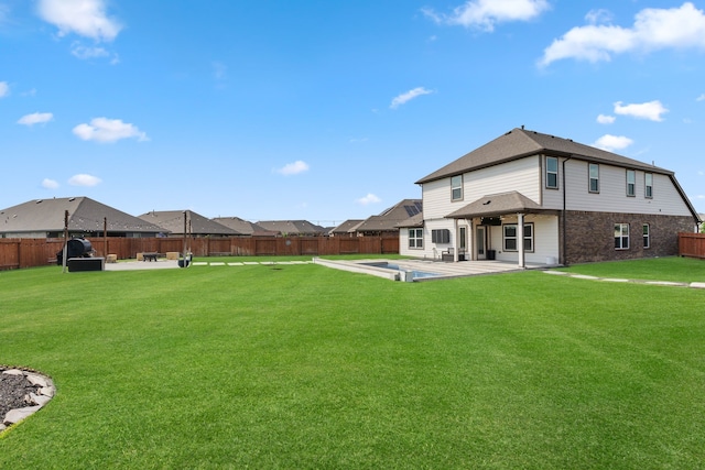 back of house featuring a patio, a fenced backyard, a lawn, and brick siding