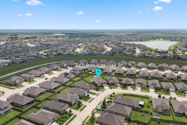 drone / aerial view featuring a water view and a residential view