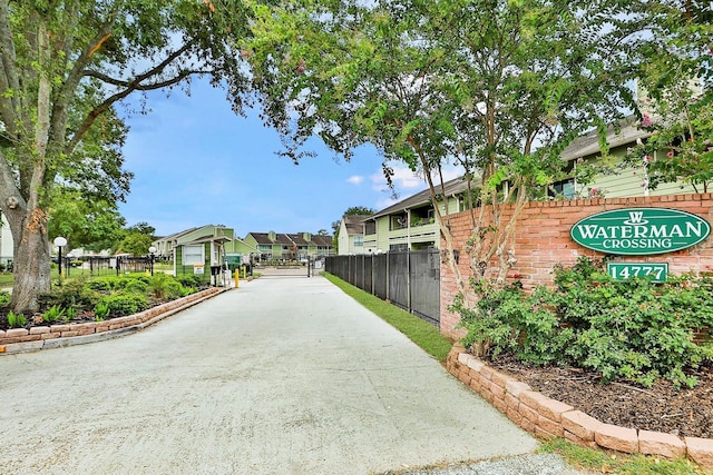 view of property's community featuring a residential view and fence