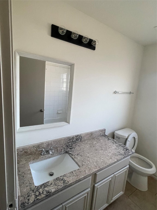 bathroom featuring tile patterned floors, vanity, and toilet