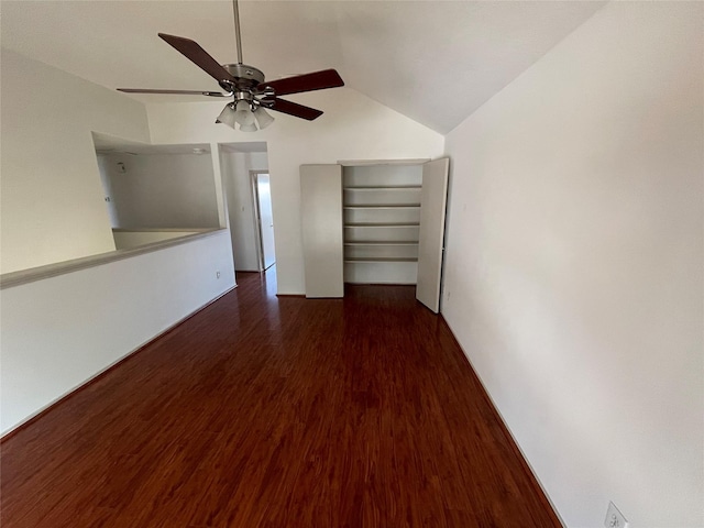 spare room with ceiling fan, vaulted ceiling, and wood finished floors