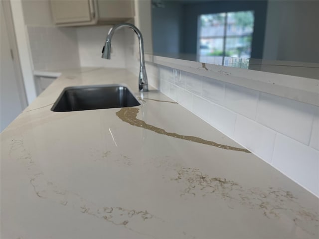 room details featuring a sink and backsplash