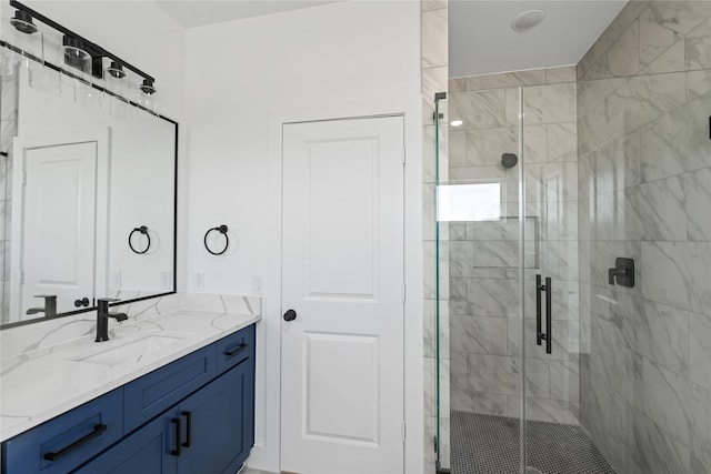 bathroom with vanity and a shower stall