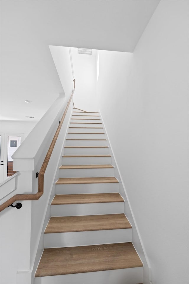 stairway featuring wood finished floors