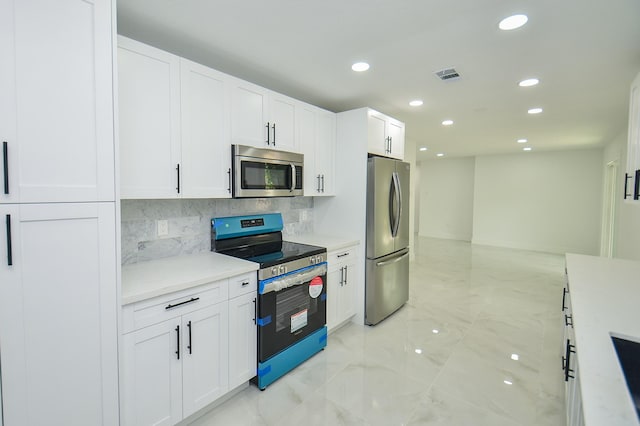 6107 Kuldell Dr, Houston, TX 77074 - kitchen featuring stainless steel appliances, light marble finish floors, recessed lighting, tasteful backsplash, and white cabinetry