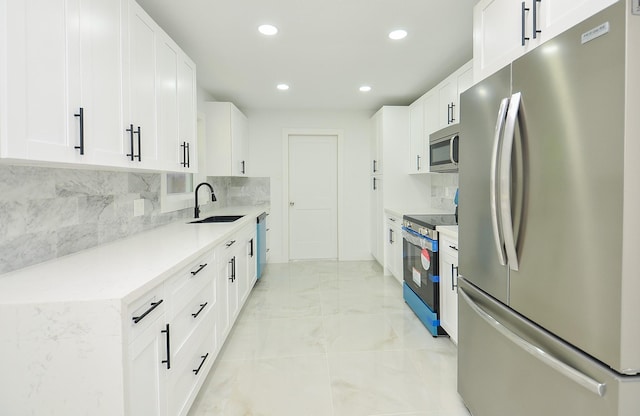 6107 Kuldell Dr, Houston, TX 77074 - kitchen featuring appliances with stainless steel finishes, recessed lighting, decorative backsplash, white cabinets, and light marble finish floors