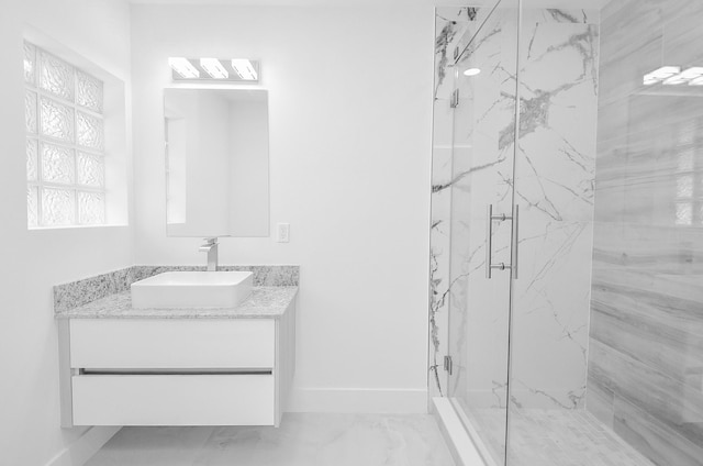 6107 Kuldell Dr, Houston, TX 77074 - bathroom featuring a marble finish shower, vanity, and marble look tiles