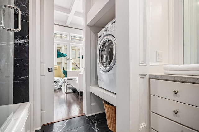 washroom with marble finish floor, washer / clothes dryer, and laundry area