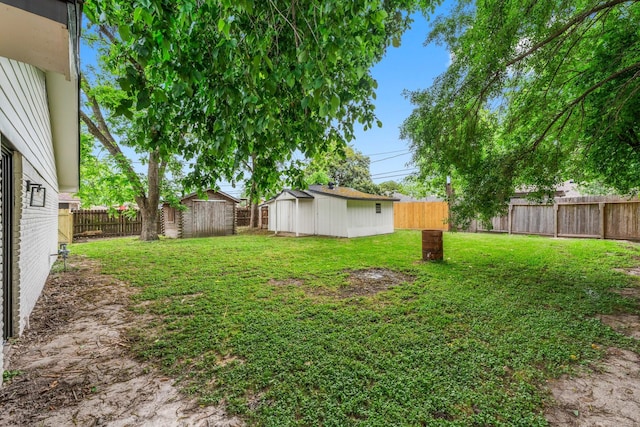 9231 Rockcliff Dr, Houston, TX 77037 - view of yard featuring an outdoor structure, a fenced backyard, and a storage unit