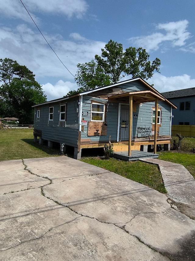 bungalow-style house with covered porch and a front yard