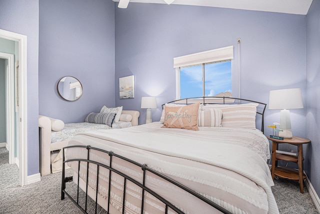 carpeted bedroom with baseboards, high vaulted ceiling, and ceiling fan