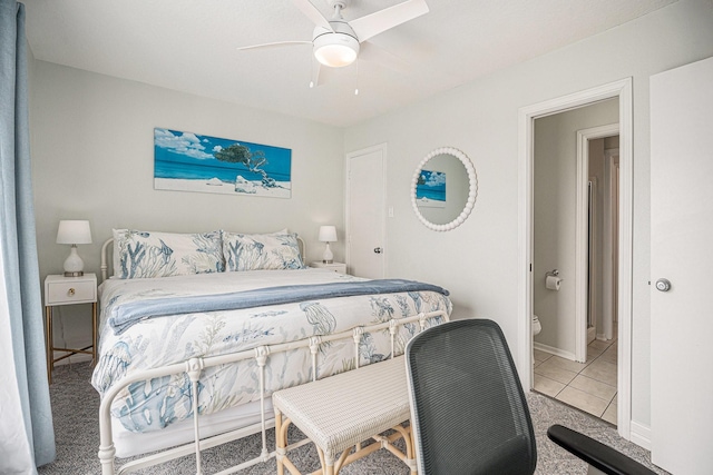 tiled bedroom with ceiling fan and baseboards