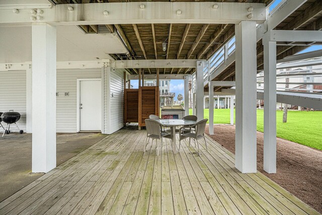 deck featuring stairway, a yard, and outdoor dining area