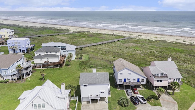 aerial view with a water view, a residential view, and a view of the beach
