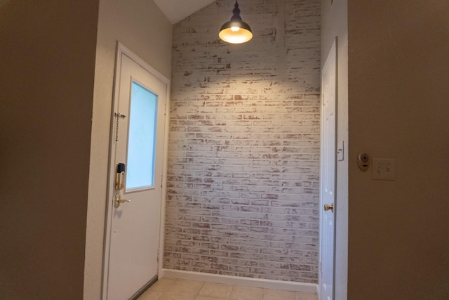 1527 Carbonear Dr, Channelview, TX 77530 - doorway to outside featuring lofted ceiling, brick wall, and baseboards