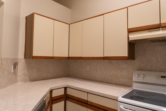 1527 Carbonear Dr, Channelview, TX 77530 - kitchen with decorative backsplash, white range with electric cooktop, light countertops, and under cabinet range hood