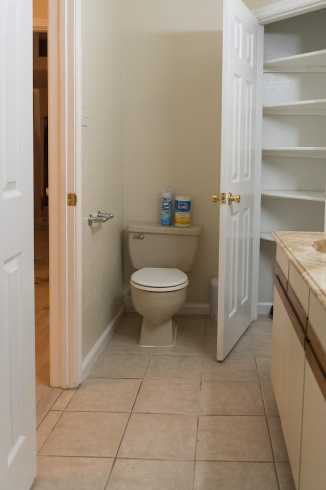 1527 Carbonear Dr, Channelview, TX 77530 - bathroom featuring tile patterned floors, baseboards, toilet, and vanity