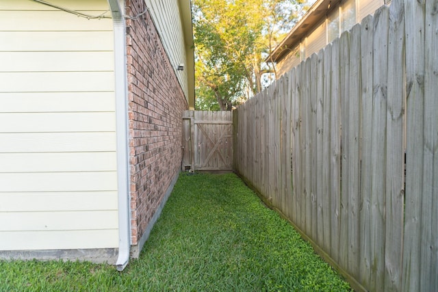1527 Carbonear Dr, Channelview, TX 77530 - view of property exterior featuring a gate, brick siding, fence, and a yard