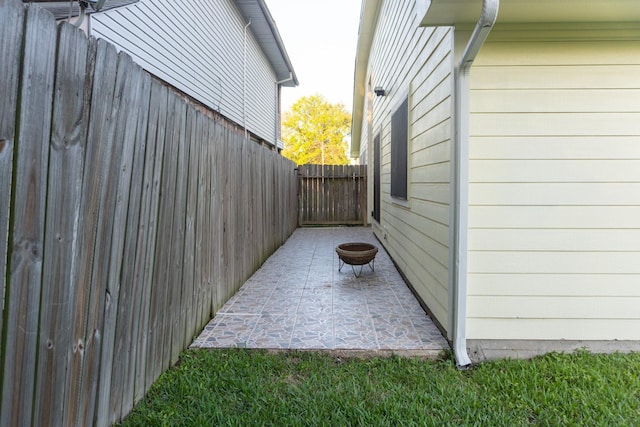 1527 Carbonear Dr, Channelview, TX 77530 - view of property exterior with fence, an outdoor fire pit, and a patio