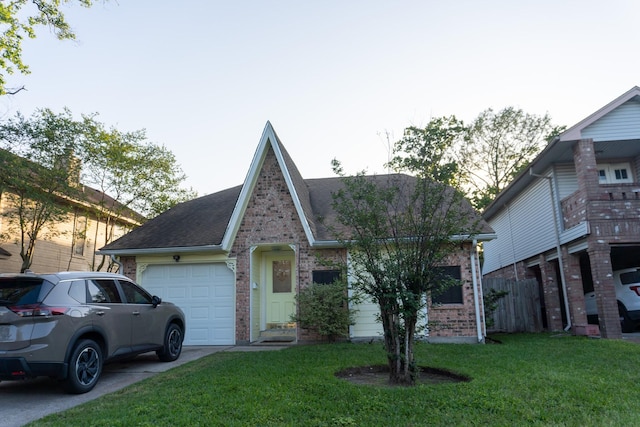 1527 Carbonear Dr, Channelview, TX 77530 - tudor-style house featuring a front yard, an attached garage, a shingled roof, and brick siding